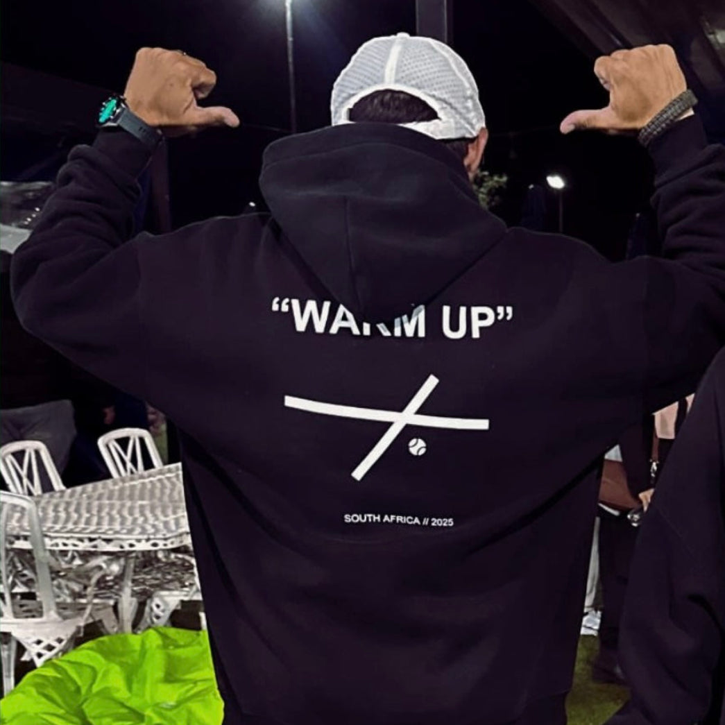 Customer wearing the black Warm Up hoodie at night
