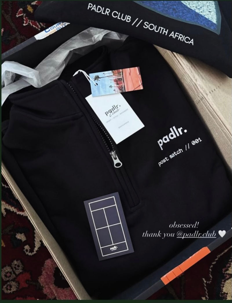 Customer Instagram story showing an unpacked black Padlr Club quarter zip