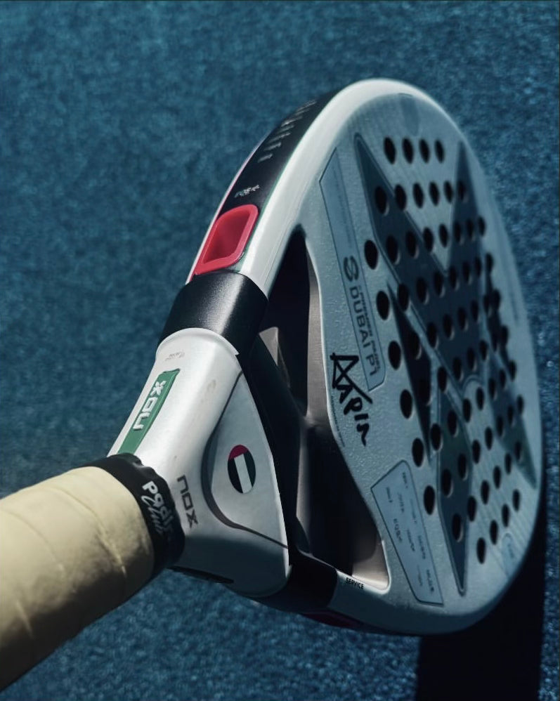 Padlr Club overgrip fitted to a padel racket on a blue court